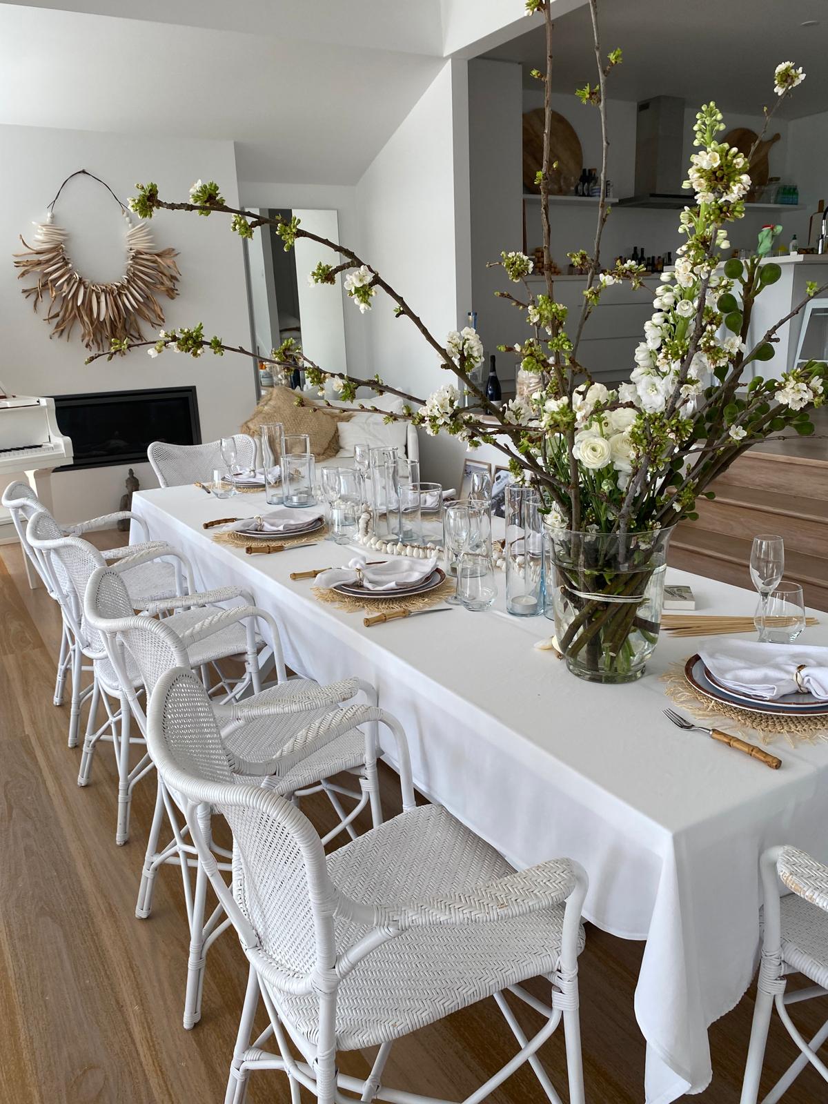 Elegant dining table with spring blossom centerpiece