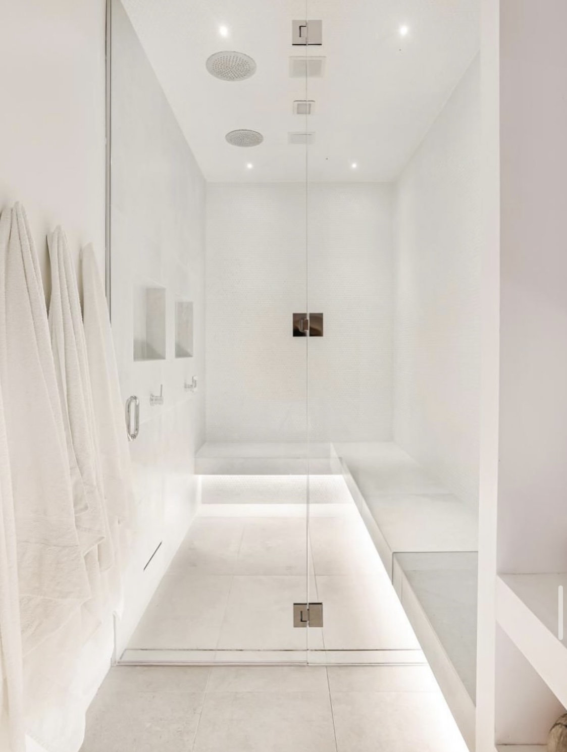 All-white steam shower with LED underlighting