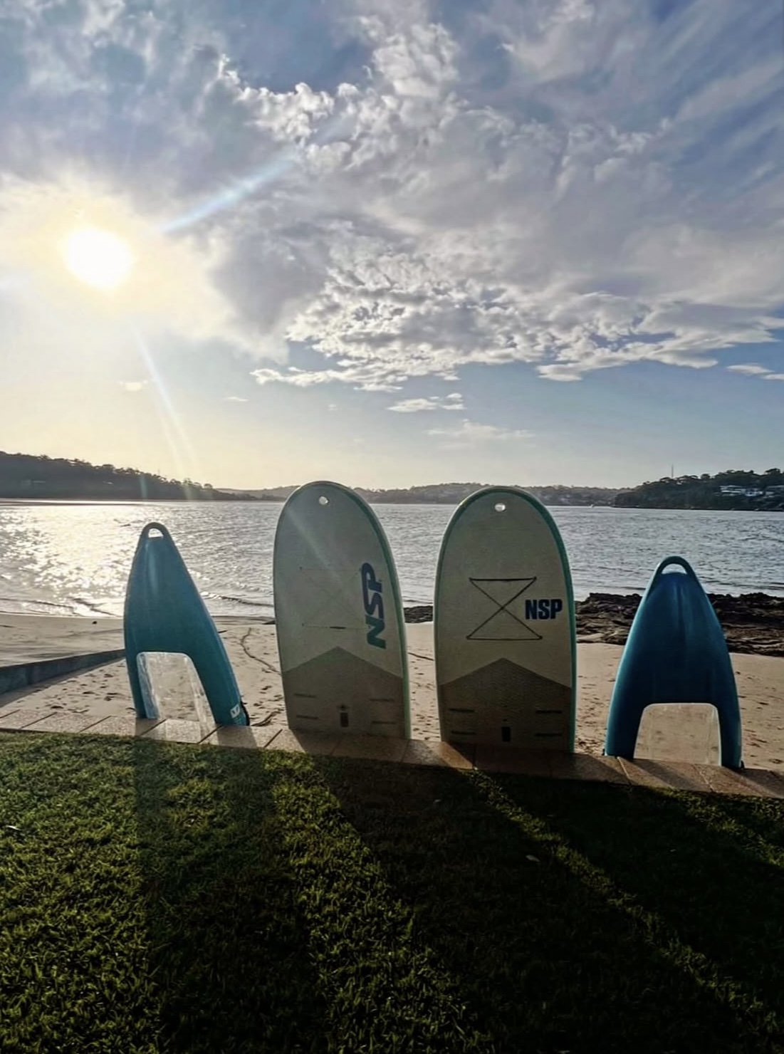 NSP SUP boards on the beach at sunrise
